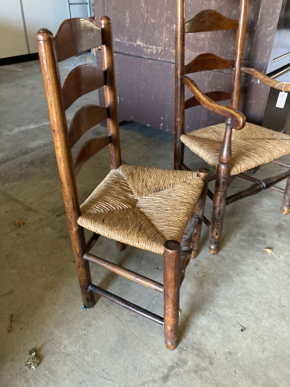 A set of eight rush seat ladderback dining chairs (two with arms)